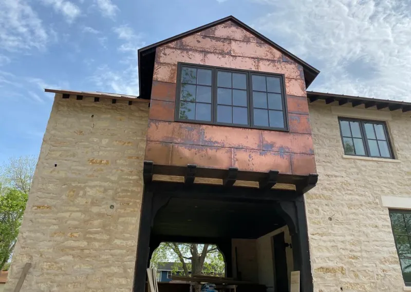 Copper metal panel facade on a stone building for Skylight Installation in Boonville